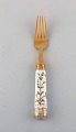 Michelsen for Royal Copenhagen. "Flora Danica" lunch fork made of gold plated 
sterling silver. Porcelain handle decorated in colors and gold with flowers.
