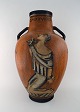 Jais Nielsen for Royal Copenhagen. Colossal floor vase with handles in glazed 
ceramics. "Abraham sacrifices his son Isac". Museum Quality. Dated 1927.
