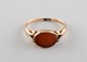 Scandinavian goldsmith. 14 carat gold ring adorned with red agate. Mid 20th 
century.
