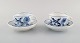 Two antique Meissen "Blue Onion" coffee cups with saucer in hand-painted 
porcelain. Early 20th century.
