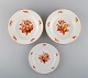 Three antique Meissen porcelain plates with orange hand-painted flowers. Two 
deep plates and one lunch plate. 19th century.
