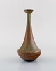 Gunnar Nylund for Rörstrand. Vase with narrow neck in glazed stoneware. 
Beautiful glaze in green and brown shades. 1960
