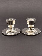 A pair of silvered candlesticks with pierced stem