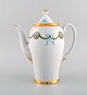 KPM, Berlin. Coffee pot in hand-painted porcelain with blue ribbons and gold 
decoration. Early 20th century.
