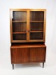 The display 
cabinet with 
glass doors and 
lower part with 
sliding doors 
in rosewood 
represents a 
...