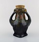 Rozenburg, Den 
Haag. Large art 
nouveau vase 
with gloves in 
glazed ceramics 
with flowers. 
1910 / ...