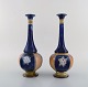 Royal Doulton, 
England. A pair 
of 
narrow-necked 
art nouveau 
vases in 
hand-painted 
porcelain. Ca 
...