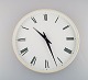 Henning Koppel for Georg Jensen. White plastic wall clock. Dial with Roman numerals. Clockwork ...