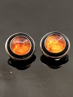 N E From sterling silver ear clips  with amber
