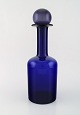 Otto Brauer for 
Holmegaard. 
Large vase / 
bottle in blue 
art glass with 
purple ball. 
...