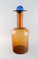 Otto Brauer for 
Holmegaard. 
Colossal vase / 
bottle in brown 
art glass with 
blue ball. ...