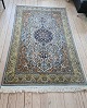 Beautiful rug wool and silk - decorated with medallion, animals and flowers. Appears in fine ...