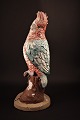 Decorative parrot cast in concrete with old paint. Height: 38cm.