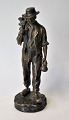 Bronze figure of walking man with hoe and hat, 19th century France. Stamped: J. Garne .... H .: ...