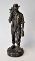 Bronze figure 
of walking man 
with hoe and 
hat, 19th 
century France. 
Stamped: J. 
Garne .... H .: 
...