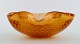 Murano bowl in amber colored mouth-blown art glass with inlaid air bubbles. 
Italian design, 1960