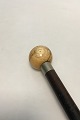 Antique walking 
stick with a 
well patinated 
head of turned 
ivory. Shaft of 
black painted 
hard ...