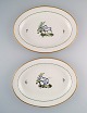 Two large oval Royal Copenhagen serving dishes in hand-painted porcelain with 
bird motifs and gold decoration. Early 20th century.
