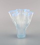 Arthur Percy 
for Gullaskruf. 
Veckla vase in 
light blue 
mouth blown art 
glass. Wavy 
shape. ...