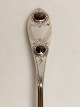 Silver spoon with two red fluffs dated 1828 and later stamped AH Length 22cm.