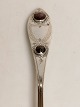 Silver spoon 
with two red 
fluffs dated 
1828 and later 
stamped AH 
Length 22cm.