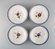 Four antique 
Royal 
Copenhagen deep 
plates in 
hand-painted 
porcelain with 
flowers and 
blue edge ...