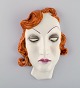 Art deco female 
face in 
hand-painted 
glazed 
ceramics. 
Germany, 1950s.
Measures: 18.5 
x 13 ...