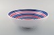 Ingrid Atterberg for Uppsala Ekeby. Large bowl in glazed stoneware. Striped 
design in blue and pink shades. Dated 1951-52.
