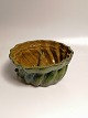 19th century 
green glazed 
pudding shape 
Height 12cm 
Diameter 
26.5cm.Province 
Robert Jacobsen 
...