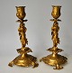 Pair of French candlesticks of gilded bronze, 19th century. Cast with putti and foliage. H .: ...