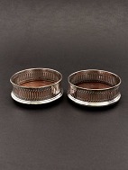 A pair of silver-plated wine coaster