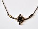 Jewelry set in 
silver, 
consisting of 
necklace and 
ear screws, 
20th century 
with grenades. 
Chain ...