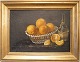 A 20th century 
still life 
painting. 
A still life; 
A table set 
with oranges in 
a basket and a 
...