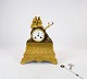 French fireplace clock of gilded bronze from around the 1820s. The clock is in great antique ...