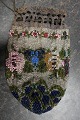 Antique Handmade bag, made of beads
This beautiful old handmade bag, from about the 
end of the 1800-years, is handmade of beads with 
embroidery which shows flowers/roses
The shape is with cords at the top that can tie 
the bag together