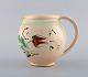 Kähler, HAK. 
Jug in glazed 
stoneware. 
Flowers on a 
cream colored 
background. 
1930 / ...