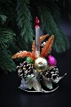 Old Christmas 
decorations 
made of metal, 
glass balls, 
branch cones 
and small 
candles in 
glass. ...