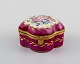 Antique lidded box in hand-painted porcelain with flowers and gold decoration on 
a purple background. Sevres style, early 20th century.
