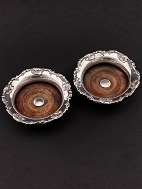 A pair of silver-plated wine coasters