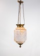 Antique pendant 
of orange 
opaline glass 
with brass edge 
and suspension 
from around 
1860. The ...