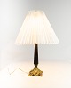 Table lamp with 
black patinated 
stem and gilded 
foot with shade 
of paper. The 
shade is ...