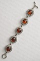 Bracelet tin 
with amber, 
length 21 cm. 
width 2.5 cm.
 Stamped 
Jörgen Denmark 
323.
