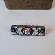 Italian Mille 
Fiori brooch - 
glass mosaic. 
Dimensions: 
1.2 x 4 cm.