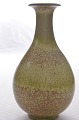 Vase of 
stoneware with 
glaze in shades 
of green on a 
brown 
background.
Vase, height 
21.5 cm. 8 ...
