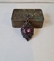 Antique medallion with beautiful purple glass stones set in patinated metal.On the back is a ...