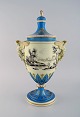 Large Dresden ornamental vase in hand-painted porcelain with classicist scenes 
and handles in the shape of angels. 19th century.
