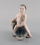 Rare Royal Copenhagen porcelain figurine. Boy sitting on fish. 1920s. Model 
number 2347.
