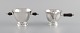 Early Georg 
Jensen sugar / 
cream set in 
sterling silver 
with handles in 
ebony. Dated 
...