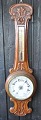 English 
barometer, 19th 
century. 
Aneroid. Carved 
oak wood. With 
temometer. H .: 
92 cm.