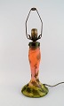 Legras, France. 
Large art 
nouveau table 
lamp in 
mouth-blown art 
glass carved 
with motifs of 
...